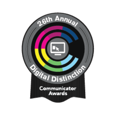 Logo for the 26th Annual Communicator Awards showcases a circular design with colorful segments and a computer screen icon at its core, embodying digital marketing agency innovation. Text reads Digital Distinction.