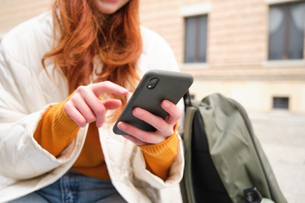 woman looking up a local business using her phone