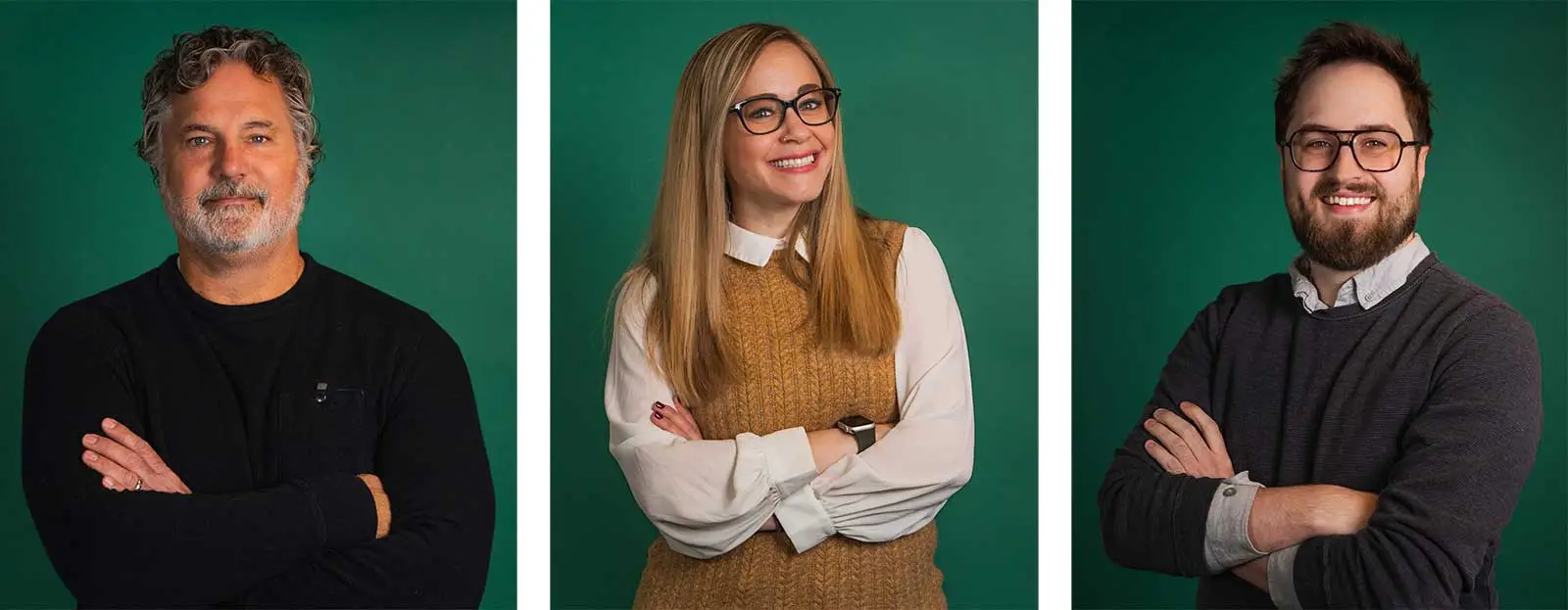 Three people stand against a green background, each smiling with arms crossed. The first is a man with curly gray hair and beard, the second is a woman with long blonde hair and glasses, and the third is a man with dark hair, beard, and glasses.